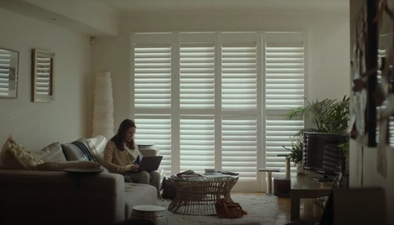 Woman work from home sitting on the sofa - DIY Easy Fit Shutters